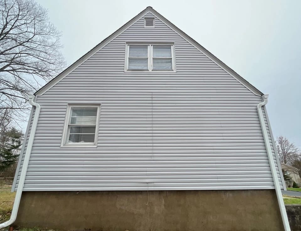 North Royalton Power Washing technician performing detailed house washing in North Royalton residential area